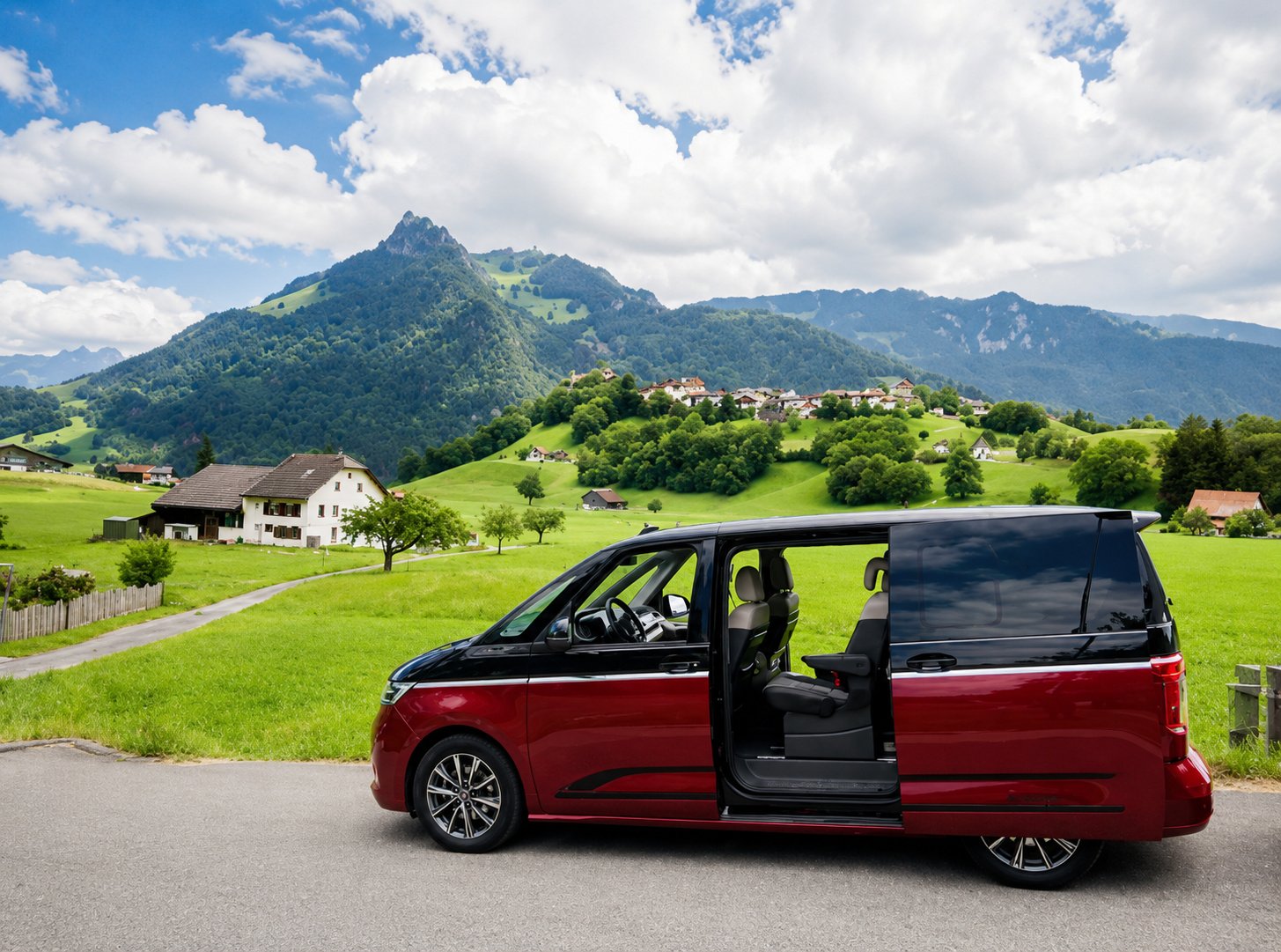 VW Multivan with sliding door open in front of Gruyères
